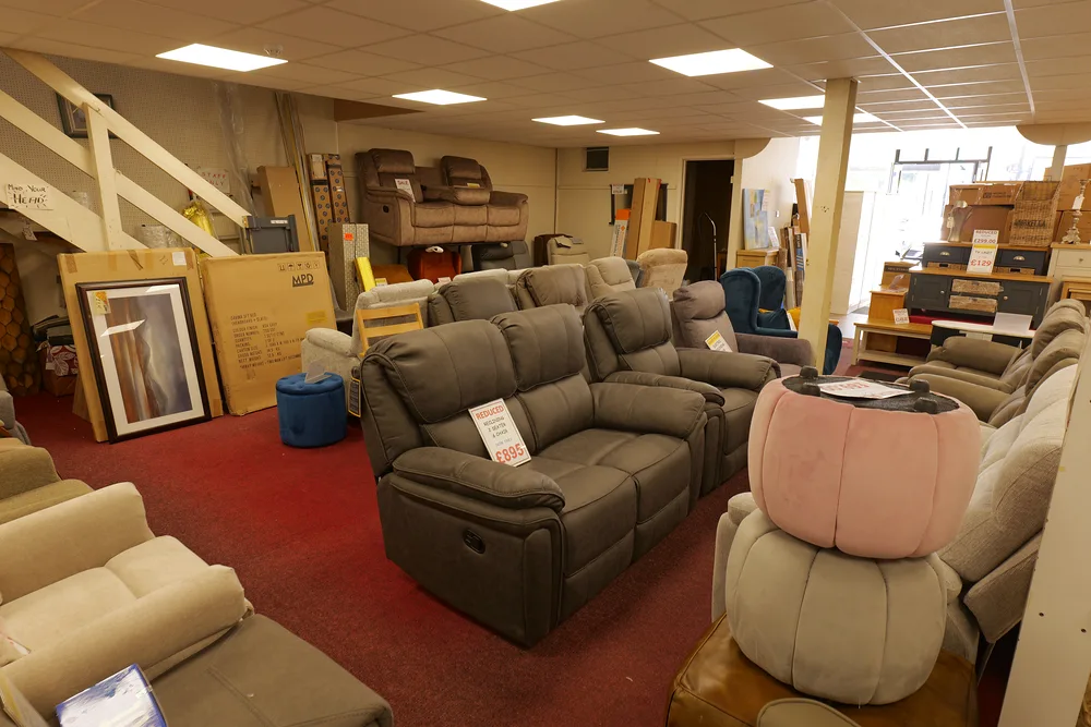 Sofas and recliner chairs displayed together in the Armagh furniture showroom