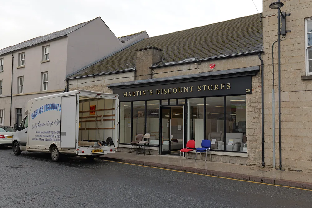 The Armagh shopfront viewed along Dobbin Street with a delivery vehicle outside